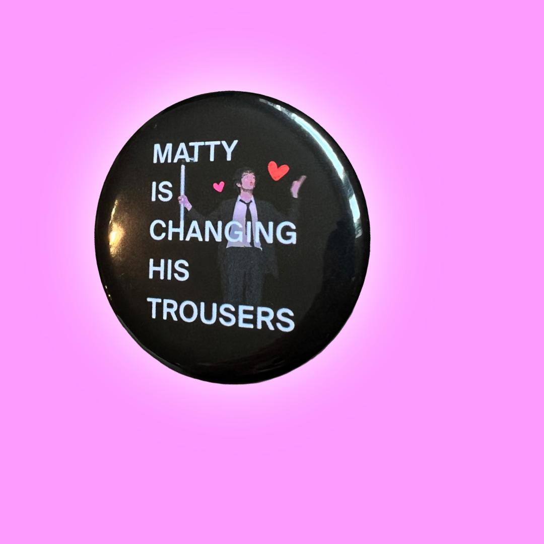 Matty is changing his trousers button badge